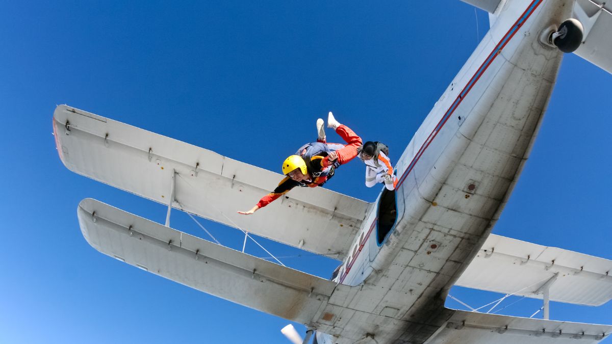 A man skydiving and jumping off the plane